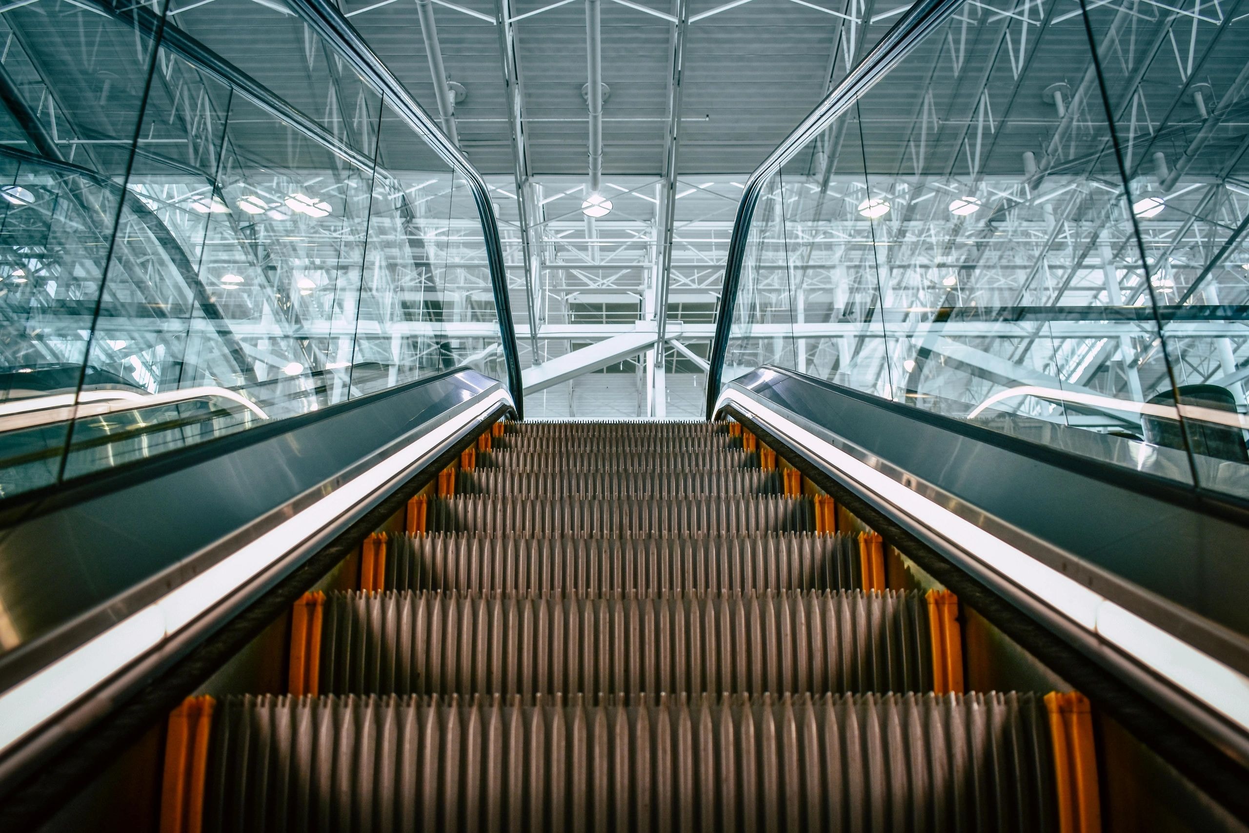 Modern escalator with orange panels in transit hub