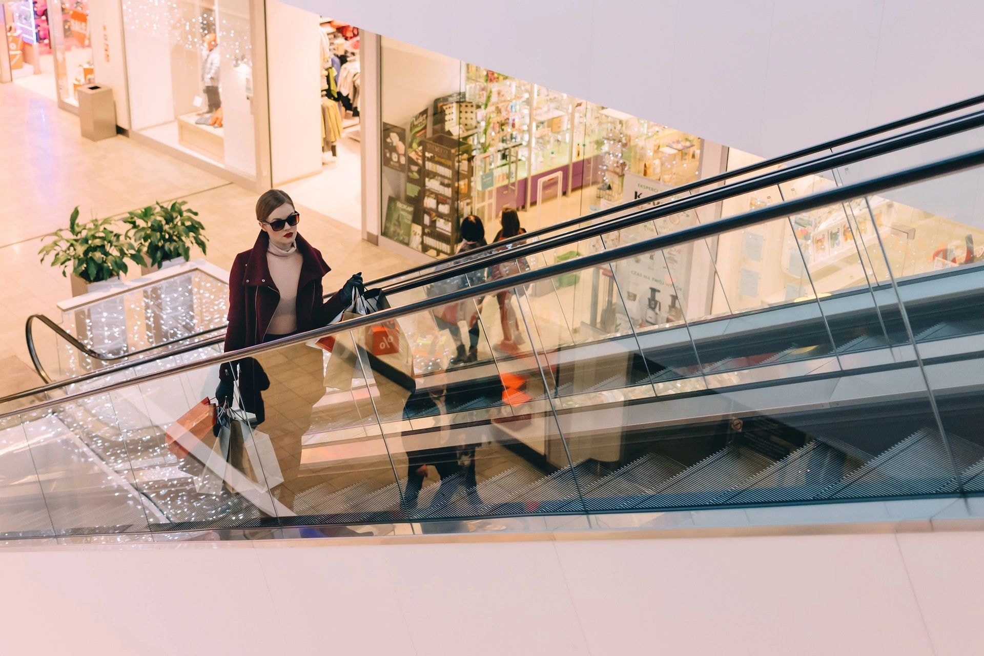 Shoppers on escalator in mall
